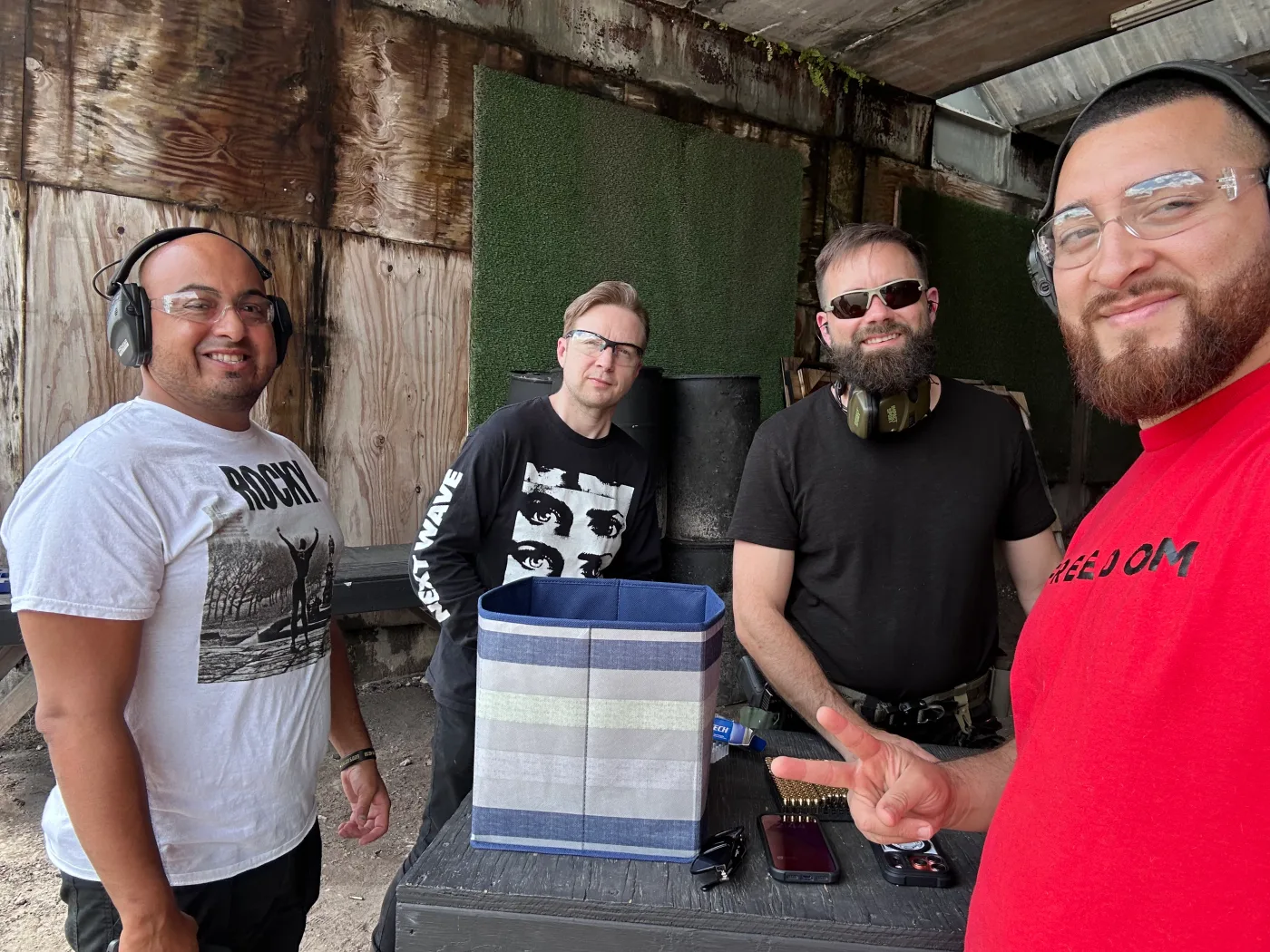 Four members of the Barley and Mane team in ear protection and safety glasses at an outdoor shooting range